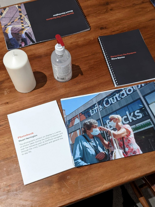 Pandemic photobook on the table with hand sanitizer